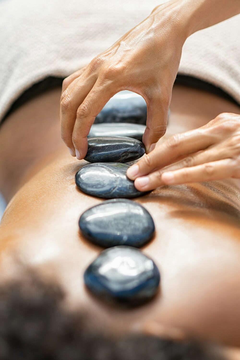 hot-stone-massage-at-spa-e1725330648308